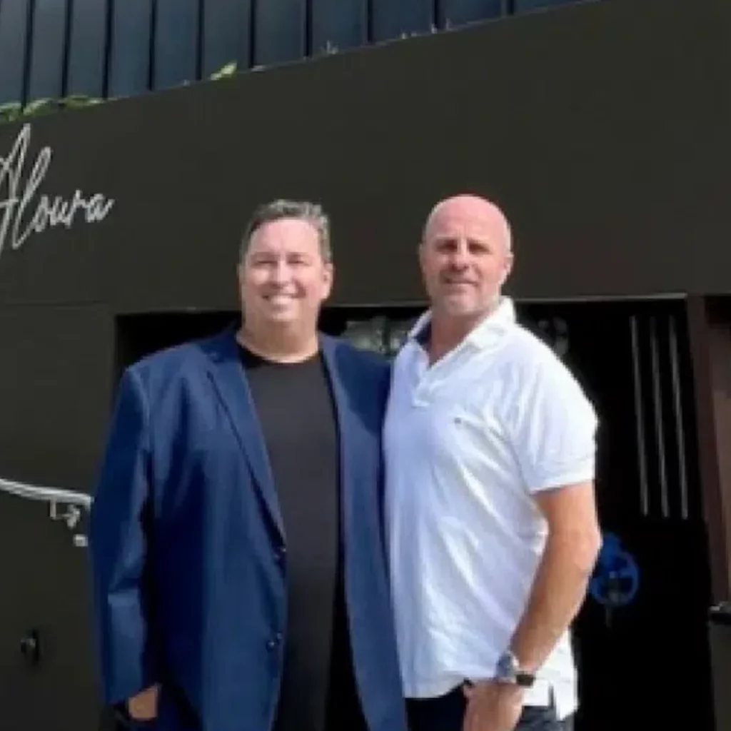 Two FirstPoint Mortgage Brokers team members smiling and posing outside their Cronulla office, providing personalised