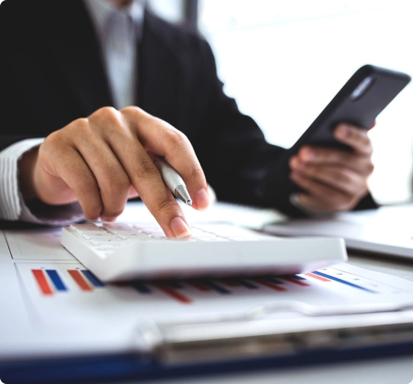 A person reviewing financial documents and using a calculator, illustrating mortgage options with First Point