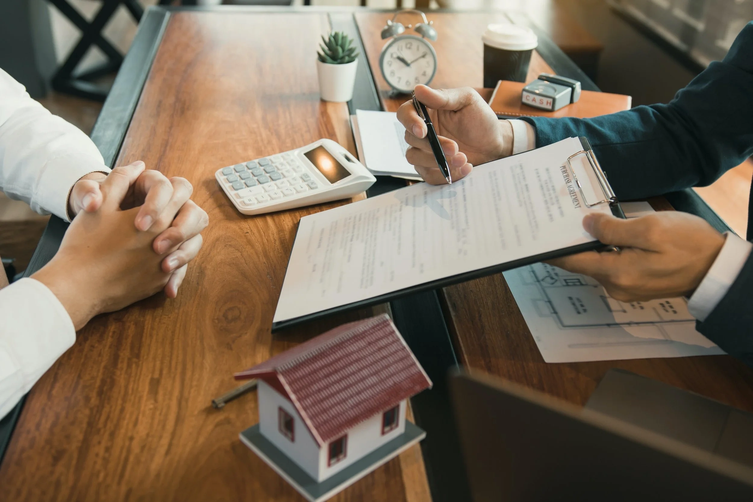 A broker reviews loan documents with a client, demonstrating personalised guidance for home loan applications