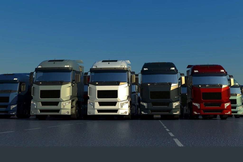 Lineup of various coloured trucks illustrating asset finance options for Australian businesses.