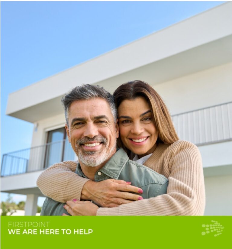 Smiling couple embracing in front of a modern home, representing SMSF property investment in Australia.