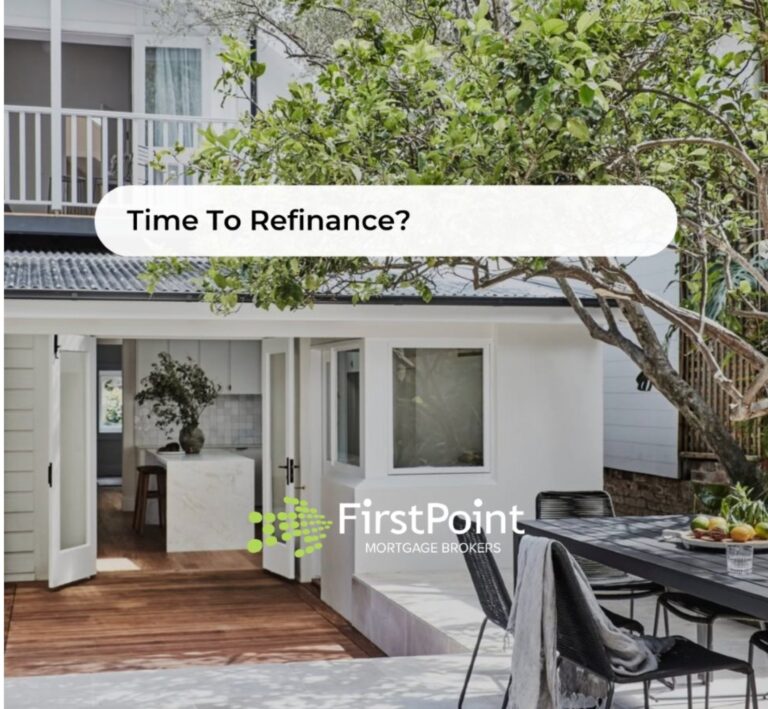 A modern home exterior with a garden and outdoor dining area, suggesting time to refinance