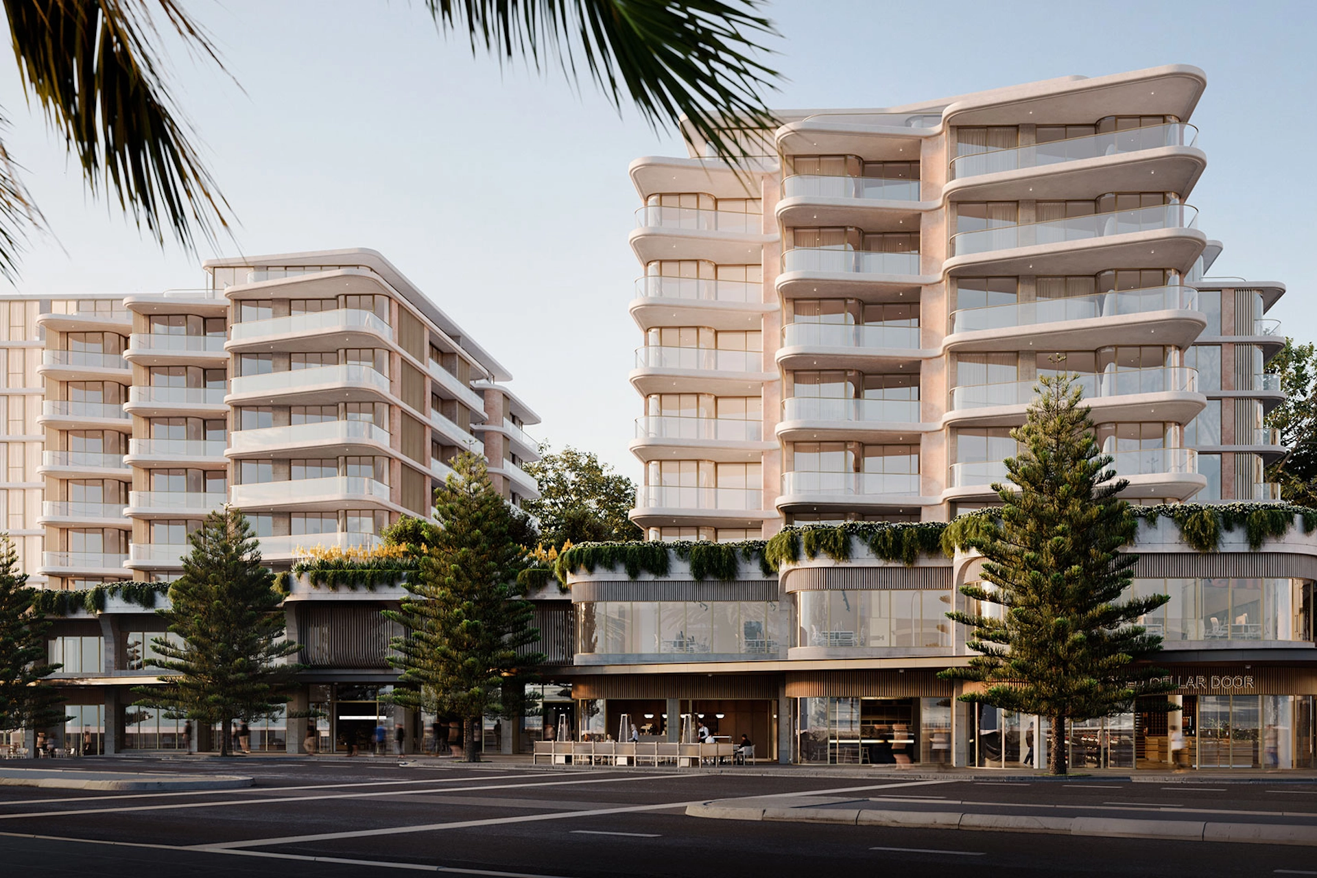 Modern apartment complex with curved balconies and landscaping, illustrating investment property potential.
