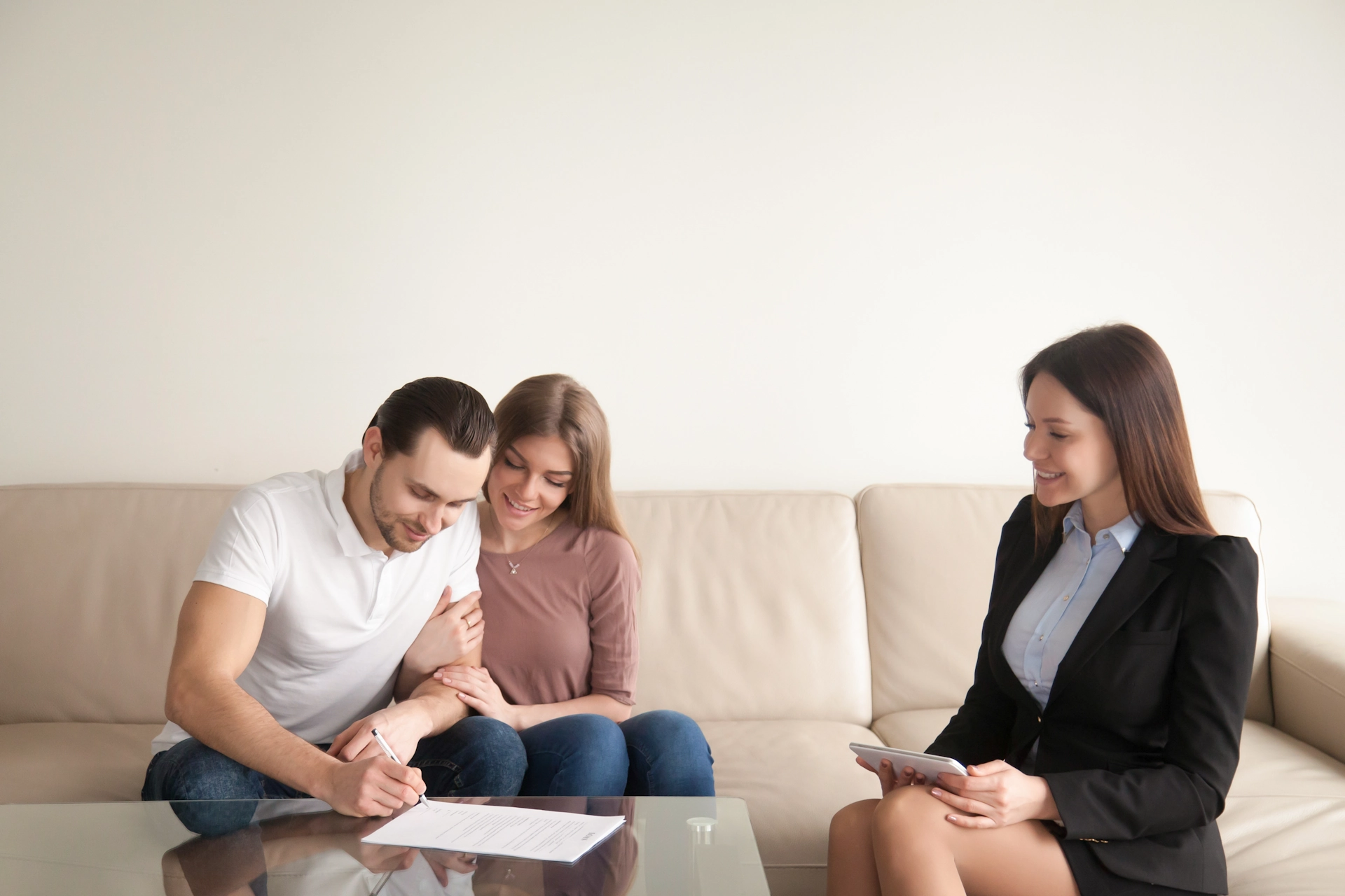 Couple signing finance documents with a realtor in Australia