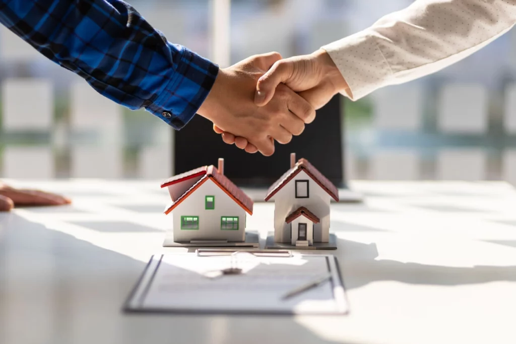 Handshake over property models illustrating investment loan structuring in Cronulla.