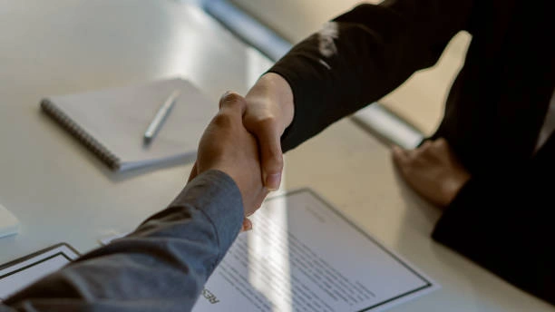 Handshake between a broker and client discussing property investment loans in Australia.