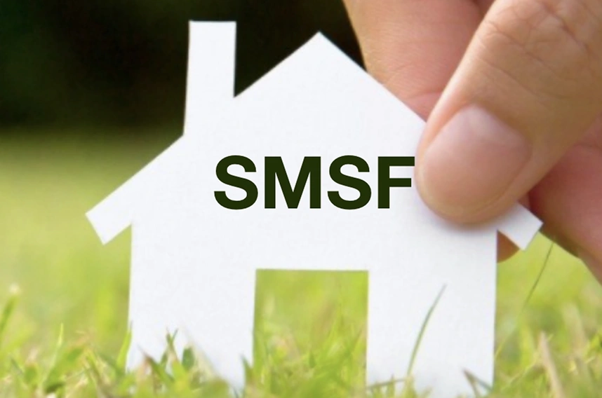 A hand holding a paper house cutout with "smsf" written on the front, illustrating super