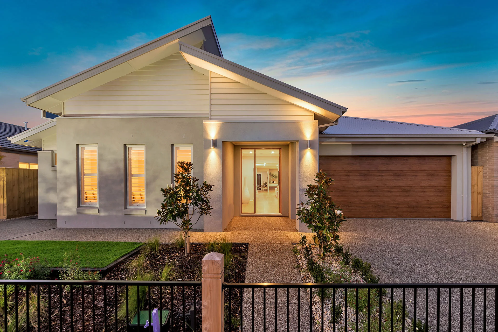 Modern home with warm lighting at dusk, representing property lending options in Australia.